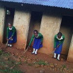 Female Pupils Sweeping around Old Toilets
